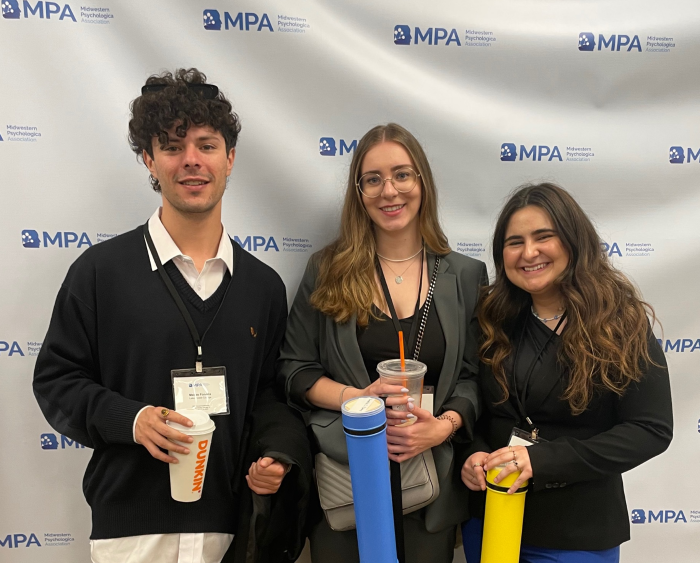 students before presenting research at MPA, posing with coffee drinks